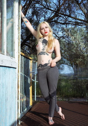 18 year old girl Megan Rain removes her sandals and then clothes to pose naked